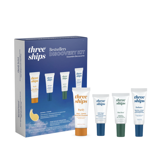 A Three Ships Best-Sellers Discovery Kit box appears with four labeled all-natural skincare tubes—Purify, Jelly Dew, Skin Hero, and Radiance—standing in front of this ideal travel-size set.