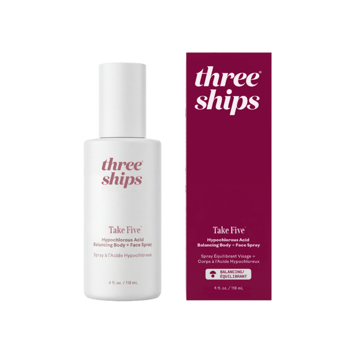A white bottle of Three Ships Take Five™ Balancing Body + Face Spray - Hypochlorous Acid stands beside its matching maroon and white box, both featuring hypochlorous acid as the key ingredient and showcasing this antibacterial spray as a gentle, effective option for soothing skin care.