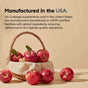 A woven basket of red apples rests on a beige surface with apples scattered nearby. Above, text highlights that Codeage Akkermansia probiotics are made in the USA following high-quality standards.