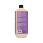 A bottle of Alaffia EveryDay Shea Bubble Bath, viewed from the back, shows the product description, usage directions, ingredients—including fair trade shea butter and soothing lavender oil—and a barcode on a purple label. This sulfate-free bubble bath is crafted for gentle cleansing and relaxation.