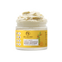 A jar of Dr. Jacobs Naturals Shea Souffle Body Butter in Nourishing Almond scent, with a creamy whipped texture spilling over the top and a yellow label featuring product details and icons for deep hydration.