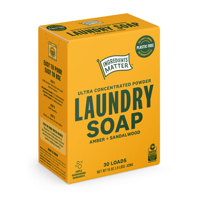 A yellow box of Ingredients Matter Laundry Soap Powder 30 Load in amber and sandalwood scent, featuring easy-pour, plastic-free, hypoallergenic packaging.