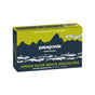 A rectangular box of Patagonia Provisions White Anchovies Spicy in extra-virgin olive oil, with fish and mountain graphics on a blue and yellow background. Responsibly sourced with 22g protein per serving.