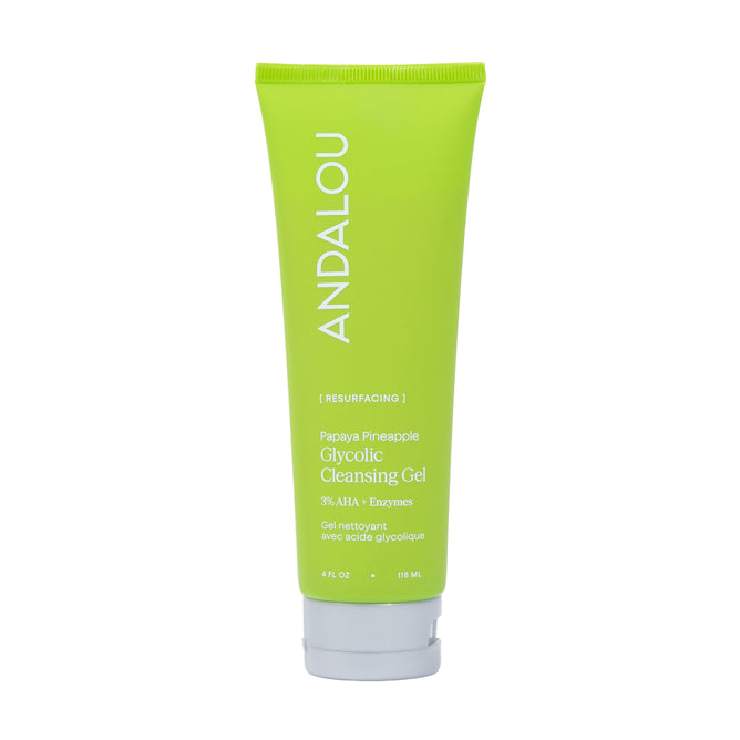 A green tube of Andalou Naturals Resurfacing Glycolic Cleansing Gel with white text, standing upright against a white background. This cleansing gel gently exfoliates to boost radiance for a fresh, glowing complexion.