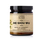 A dark glass jar labeled Anima Mundi HE SHOU WU, Hair Strength, features a beige label with botanical art; this herbal supplement is inspired by Traditional Chinese Medicine to support hair vitality. Net Wt 5oz/142g.