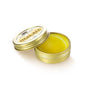 A small, round open tin of Anima Mundi HEAL-ALL Arnica Relief Balm, Nourish, Soothe + Repair with yellow balm inside and its lid partially on top, set against a white background.
