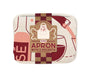 A folded cotton apron by The Neighborgoods with a wine and food print, packaged with a label reading “Wine Apron with 2 Pockets,” an apron illustration, and “Fully Adjustable Straps”—a must-have kitchen essential.