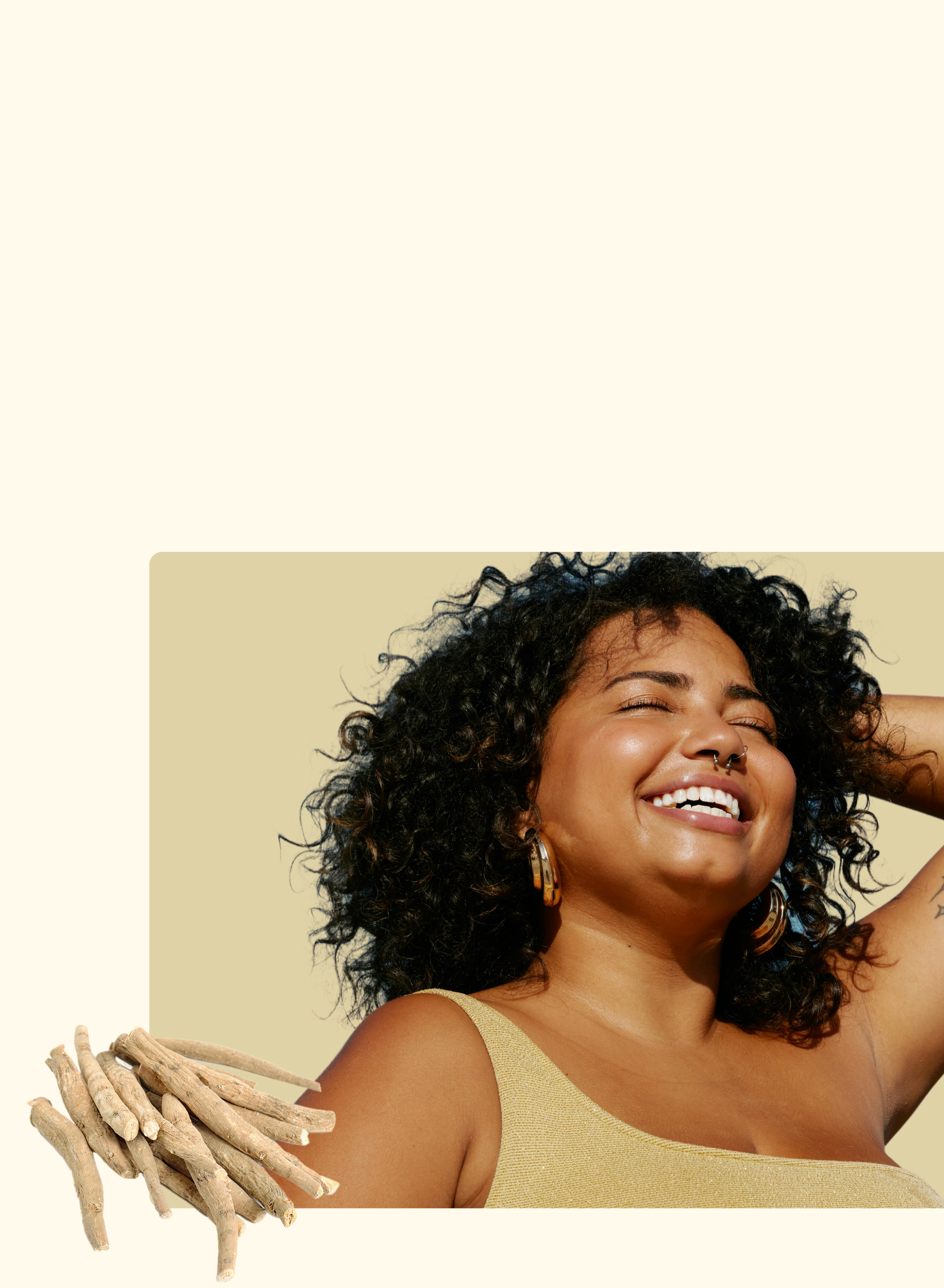 A smiling woman with curly hair and gold hoop earrings enjoys sunlight against a beige background. In the lower left corner, there are several ashwagandha roots.