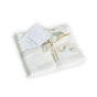 A folded set of Avocado Organic Indian Cotton 400 TC Pillow Case Set in natural color, elegantly tied with a ribbon and featuring a white Avocado brand tag.