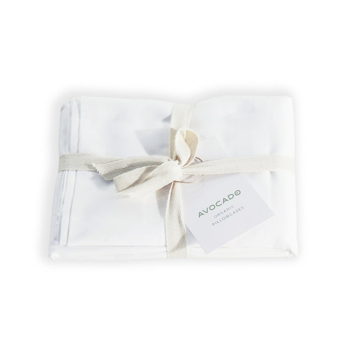 A set of white Avocado Organic Indian Cotton 400 TC Pillow Cases, neatly folded with a cream ribbon and tag—crafted from GOTS certified organic cotton with a soft sateen finish.