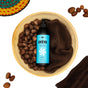 A bottle of Ayeya Moisturizing Body Lotion rests in a wooden bowl with shea nuts, a towel, and a woven basket—ideal for replenishing your skin.