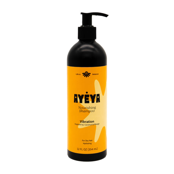 Ayeya Nourishing Shampoo comes in a black pump bottle with an orange label. Made for dry hair, its moisturizing formula features clean ingredients like coconut and mango in a 12 fl oz (354 mL) size.