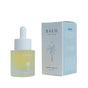 A bottle of Baeo Bare Glow - Radiant Face Oil with a dropper cap sits beside its light blue and white box, adorned with a palm tree illustration—ideal for restorative hydration and a radiant complexion.