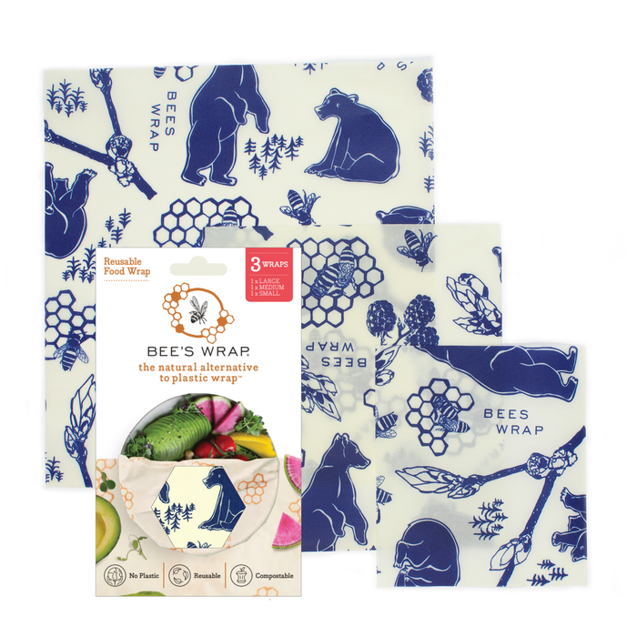The Bees Wrap Assorted 3 Pack features three reusable food wraps with blue bear and honeycomb patterns, shown alongside packaging that highlights this eco-friendly plastic wrap alternative.