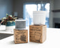 Two Epic Water Filters USA Pure XP Replacement Filters are placed on their boxes atop a white countertop, with a plant and window softly blurred in the background, highlighting advanced NSF-certified water filtration for your peace of mind.
