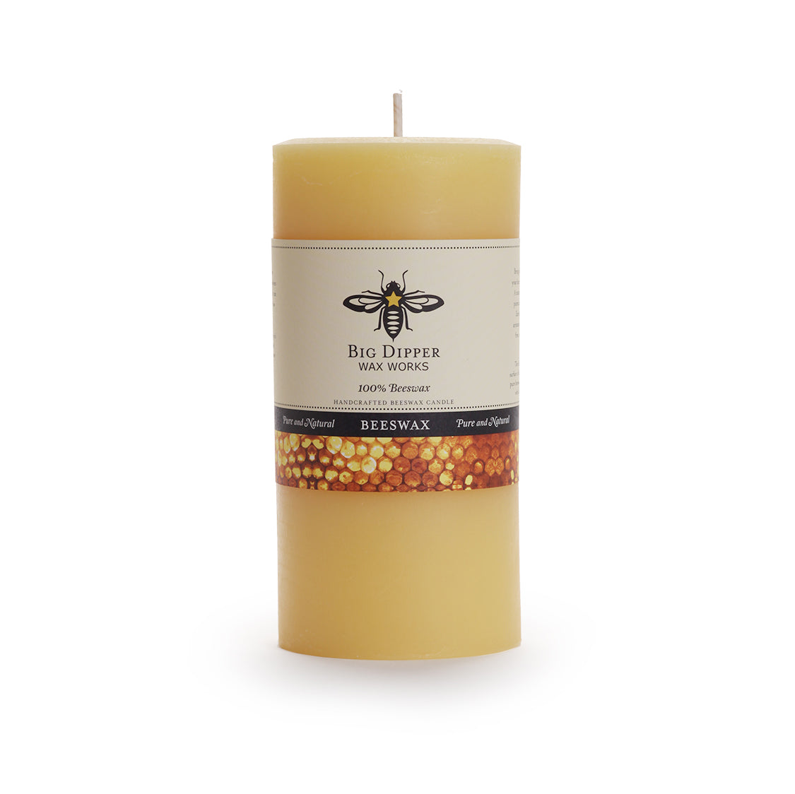 The 100% Pure Beeswax Pillar Candle Natural by Big Dipper Wax Works is a tall, cylindrical candle with a bee and honeycomb label—perfect for a toxin-free, eco-friendly home.