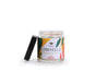 A Big Dipper Wax Works Citronella Apothecary Glass Candle, featuring a vibrant abstract design and a removed black lid resting beside it, sits on a white background—an ideal outdoor candle to elevate your patio or garden ambiance.
