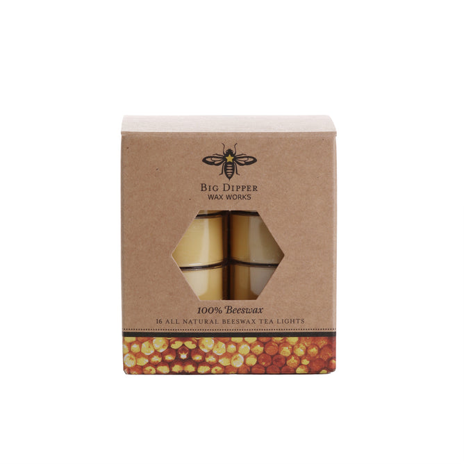 A box of Big Dipper Wax Works Pure Beeswax Tea Lights Natural features a hexagonal window displaying the candles, brown packaging with a bee logo, honeycomb pattern at the base, and emphasizes their natural aroma.