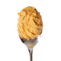 A silver spoon holds a generous scoop of Big Spoon Roasters Banana Flax Wag Butter peanut butter for dogs, isolated on a white background.