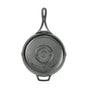 The Lodge Blacklock Triple Seasoned Skillet is pictured from above with its embossed base visible. This black, lightweight cast iron skillet features a long handle and small helper handle for easy use.