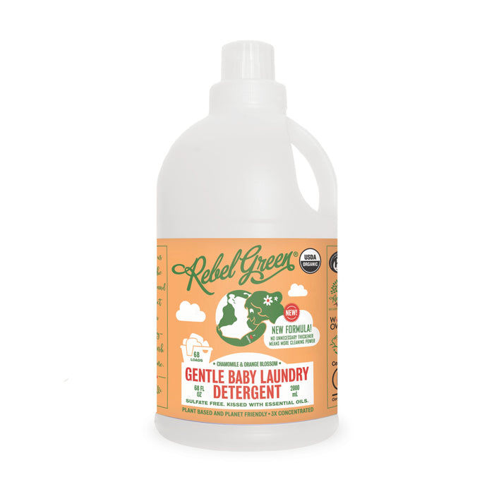 A bottle of Rebel Green Gentle Baby Laundry Detergent Liquid - 3x Concentrated with an orange label, green and white graphics, eco-friendly icons, and text highlighting its plant-based, sulfate-free USDA Certified organic formula.
