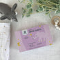 A pink box of grab green Baby Dryer Sheets (5+ Months) - Rosewood, featuring an elephant illustration, sits near a gray toy elephant and leafy branches, emphasizing natural fabric softener and static reduction.