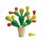 The Balancing Cactus Toy by PlanToys features removable green, yellow, and red branches—one yellow branch set aside. Made from eco-friendly materials, it’s a playful example of sustainable design.