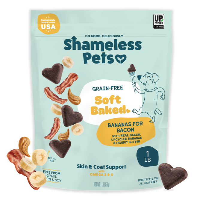 A package of Shameless Pets Bananas for Bacon Soft-Baked Dog Treats, featuring images of bacon, bananas, cashews, heart-shaped snacks, and a cute dog holding a brush.