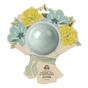 A light green Pacha Soap Co. Bath Bomb Card - Ginger Lily & Driftwood in bouquet-themed packaging with yellow and blue flower illustrations. Enjoy soothing ginger lily and driftwood notes in every soak.