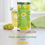 A canister of The Republic of Tea's Beauty Brain Tea, a caffeine-free blend, sits on a table with a glass of iced tea and kiwi slices. A quote below reads, “Fruity, mild, and refreshing” – Siriani.