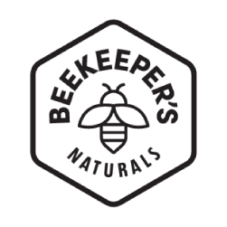 A hexagon-shaped logo with the words BEEKEEPERS NATURALS surrounding a simple illustration of a bee in the center. The text and bee are in black on a white background.
