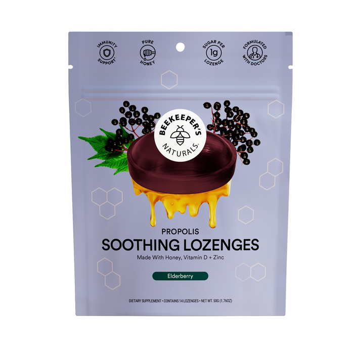 A purple pouch of Beekeepers Naturals Elderberry Soothing Lozenges with honey and propolis, featuring a honeycomb design. The packaging highlights immune support and delicious honey flavor.