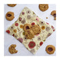 A Bee's Wrap Reusable Beeswax Food Wrap from the Assorted 3 Pack by Bee’s Wrap holds several oatmeal cookies with jam centers, while more cookies and crumbs surround this sustainable food storage solution on a white surface.