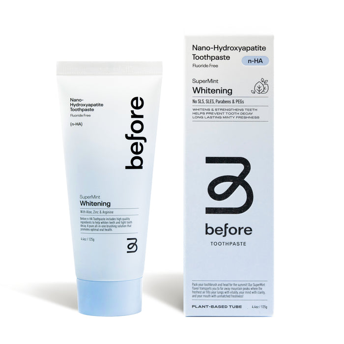 A white tube and box of before n-HA Whitening Toothpaste Fluoride-Free in SuperMint, with blue accents and text noting its a whitening toothpaste free from fluoride, SLS, SLES, parabens, and PEGs.