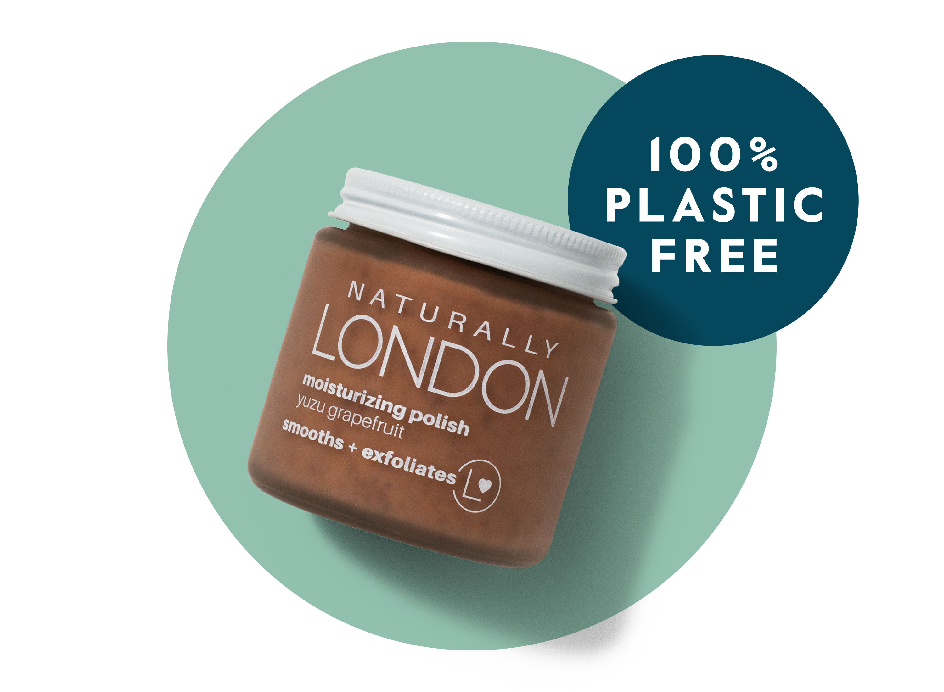 A brown jar of Naturally London moisturizing polish with a white lid is displayed on a teal circle. Text on the image reads “100% Plastic Free.” The product label mentions “yuzu grapefruit” and “smooths + exfoliates.”.
