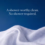 A white textured cloth against a blue background with text that reads, A shower-worthy clean. No shower required. Experience the freshness of Biom’s Full Body Wipe Go-Pack—odor-neutralizing wipes made with skin-safe ingredients.