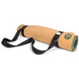 A cork yoga mat is rolled up with the Yoloha Yoga Sling and Mat Strap attached, featuring a green logo in one corner and crafted from natural cotton for an eco-friendly touch.