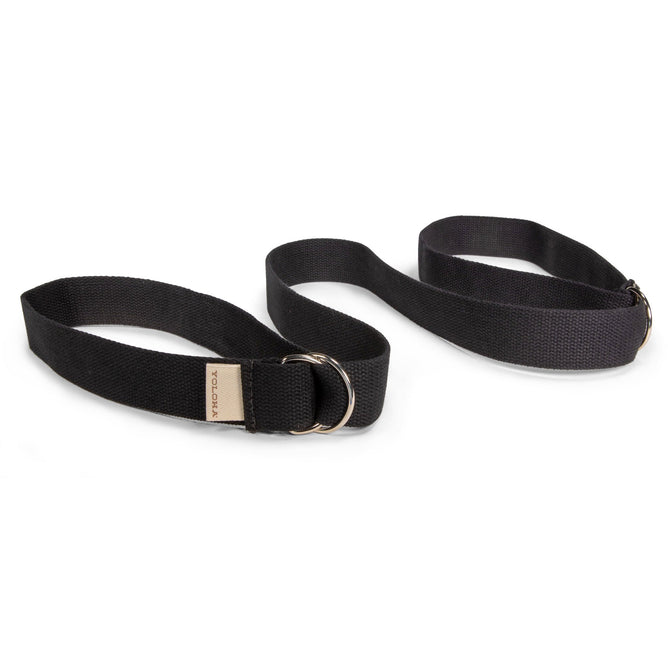 A black handmade cotton Sling and Mat Strap by Yoloha Yoga with metal D-rings, shown coiled on a white background.