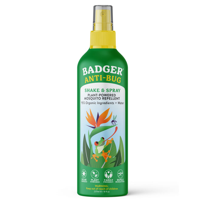 A green bottle of Badger Balm Anti-Bug Shake & Spray - Mosquito Repellent with a yellow spray cap. The label displays a cartoon badger and bird, emphasizing its plant-powered, organic ingredients such as citronella essential oil. This family-friendly bug spray is DEET-free.