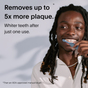 A smiling person brushes their teeth. Text reads: “SURI 3x Brush Replacement Heads remove up to 5x more plaque and whiten teeth after one use. Plant-based heads are gentle on sensitive teeth and gums.* *Vs. ADA-approved manual brush.”.