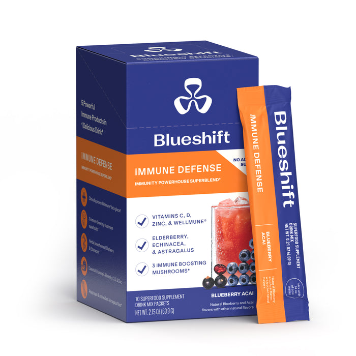 A box and single stick packet of Blueshift Nutrition Immune Defense, a blueberry acai drink mix for immune support with vitamin C, mushrooms, and elderberry. Packaging features berries and drink images.