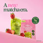 A glass of iced blume Strawberry Matcha Latte Powder with Collagen, topped with strawberries, sits before a pink packet and fresh berries on a pink backdrop. Text reads: “A new matcha era.”.