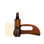 The Body Sculpting Set by Ember Wellness features a hydrating body oil, a light yellow body serum bar, and a wooden gua sha tool engraved with 