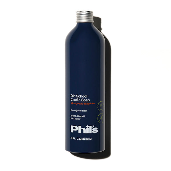 A dark blue bottle of Phils Old School Castile Soap Body Wash, featuring orange and tangerine notes, 11 fl. oz. (325 mL), stands upright on a white background—ideal for use as a refreshing body wash or gentle household cleaner.