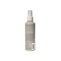 A gray Acure Bonding Leave-in Conditioner spray bottle is shown from the back, revealing a label with product details and a barcode in small, unreadable text. The bottle offers heat protection and is set against a plain white background.