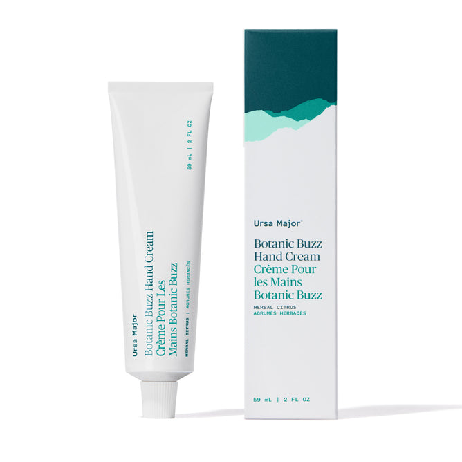A 59 ml / 2 fl oz tube and box of Ursa Major Botanic Buzz Hand Cream with green, white, and teal packaging, bergamot notes, and bilingual English/French text—ideal for rehydrating dry hands.