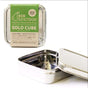 A stainless steel Solo Cube Sandwich Container by EcoLunchBox features a green label. The open bento box shows its empty interior, while another reusable container with its lid on appears in the background.