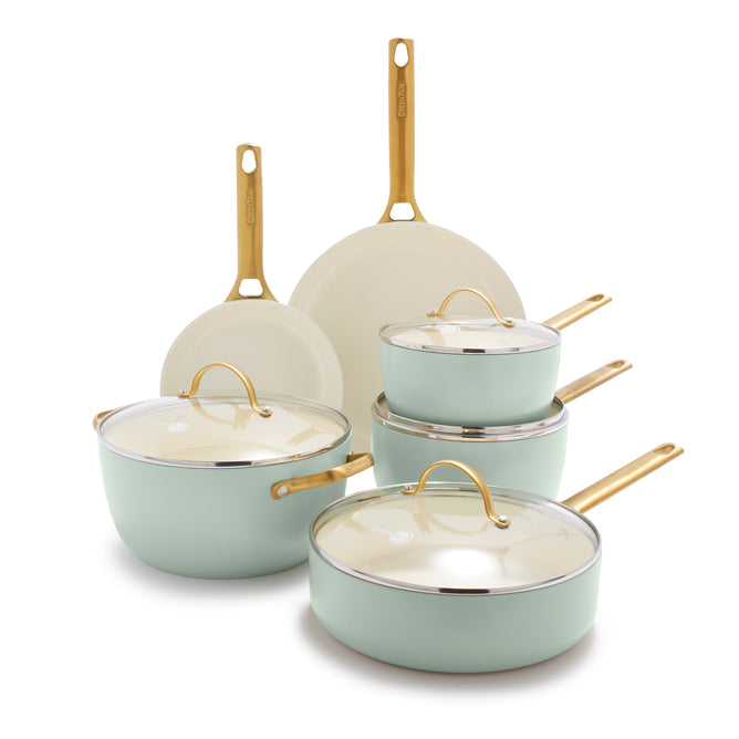 The GreenPan Reserve Ceramic Nonstick 10-Piece Cookware Set features pastel green pots and pans with gold handles, white interiors, and glass lids. Includes two frying pans, three lidded saucepans, and a stockpot—all PFAS-free.