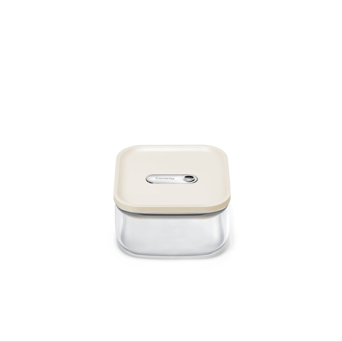 The Caraway Glass Small Container, 1 qt, is centered on a white background. It has a cream lid, is made from non-toxic glass, and features an airtight seal with a rectangular button for secure storage.