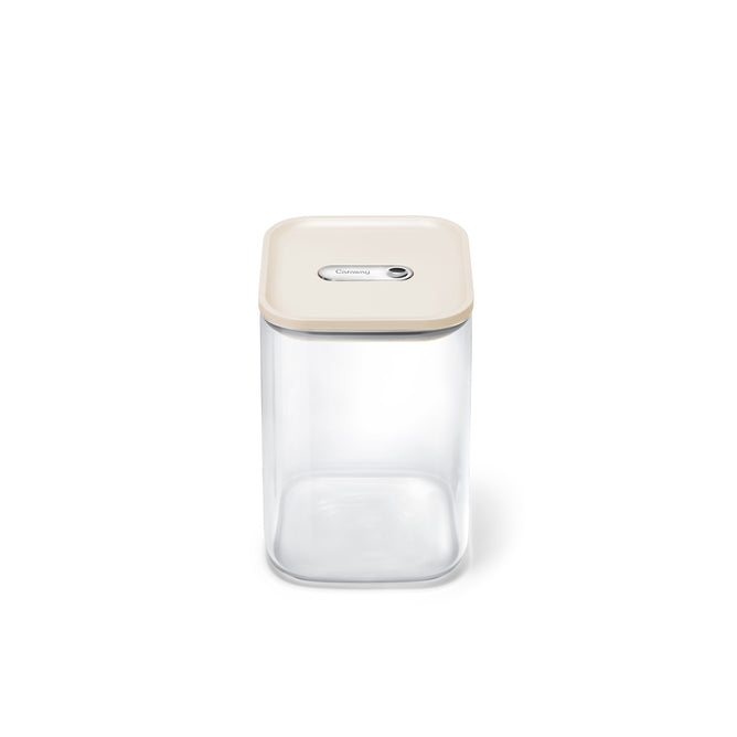 The Caraway Glass Large Container, 4 qt, features a transparent square design with a beige airtight lid and central button, shown on a plain white background.
